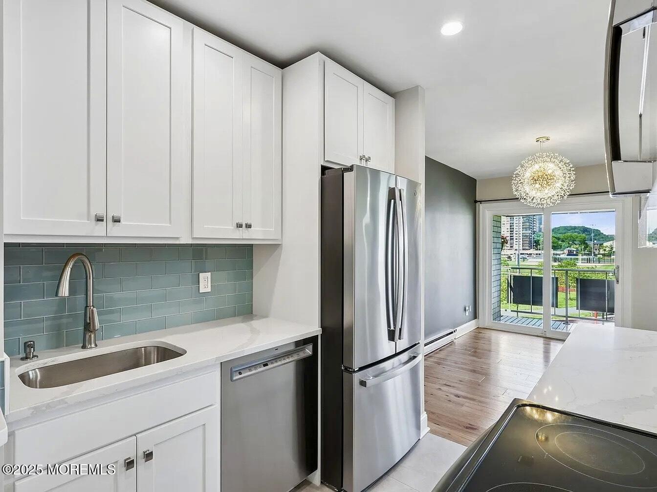 1111 River Road, Unit H20 Edgewater, NJ 07020 - Photo 6 of 14 a kitchen with stainless steel appliances granite countertop a refrigerator and a sink