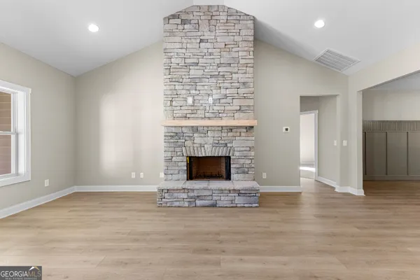 a kitchen with kitchen island granite countertop lots of counter top space and stainless steel appliances