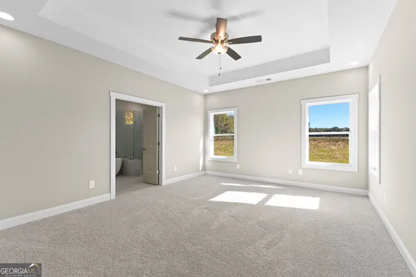 a view of a livingroom with wooden floor and a fireplace