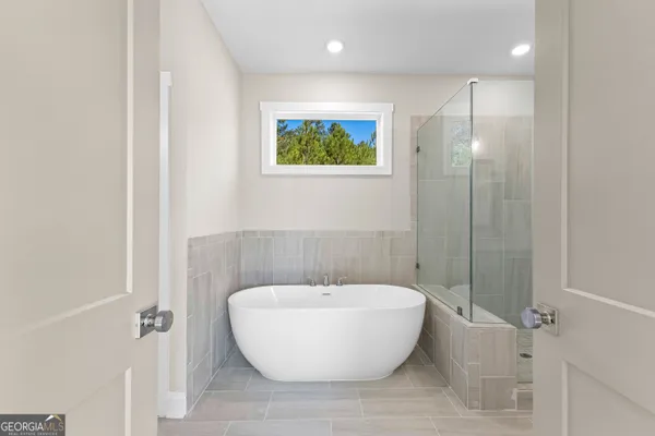 a bathroom with a bathtub and a shower