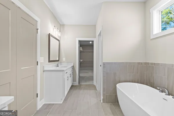 an empty room with a fan and a ceiling fan