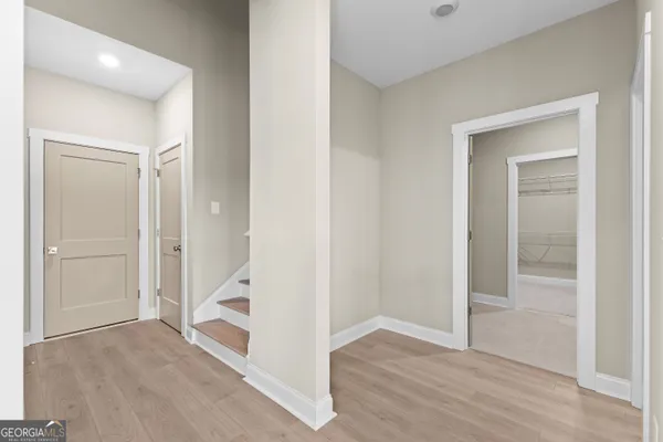 a front view of house with yard and trees in the background