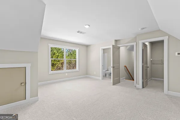 a view of a house with a big yard and large trees