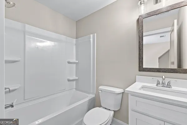 a view of a house with a wooden fence