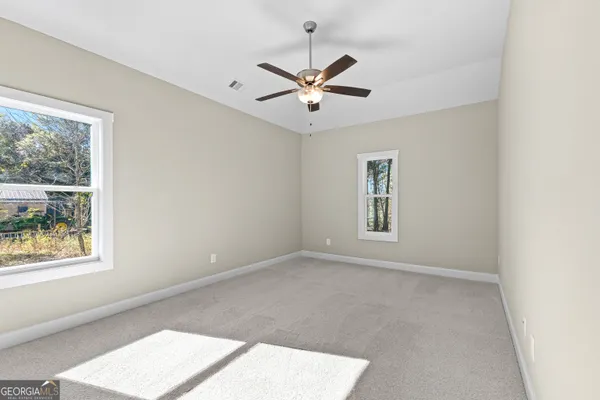 a view of a house with a big yard and large trees