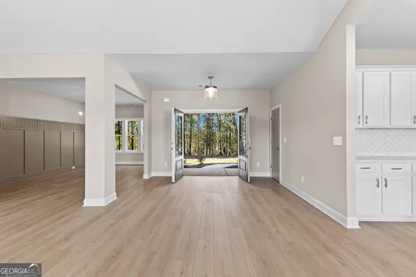a view of an entryway with wooden floor