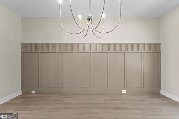 a view of an empty room with a fireplace and a window