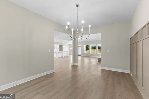 an empty room with windows and fireplace