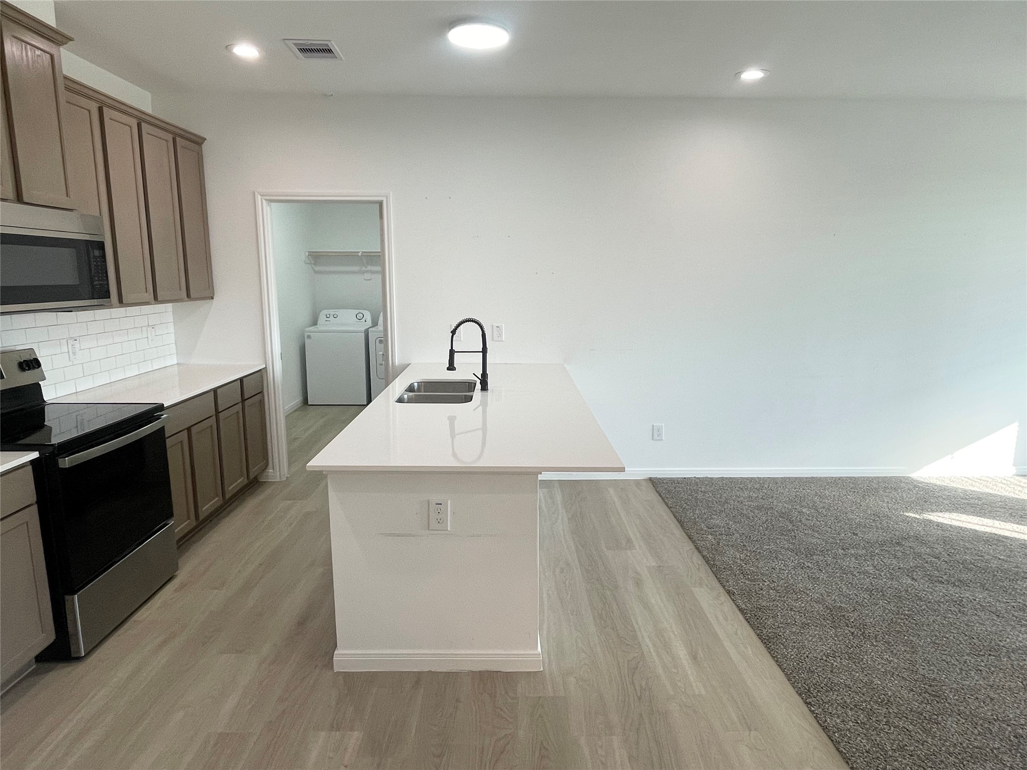 802 West Loop El Campo, TX 77437 - Photo 5 of 21 a kitchen with a sink cabinets and appliances