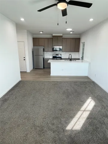 a view of kitchen with refrigerator and window