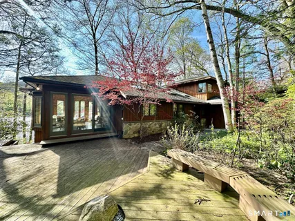 a view of a house with a yard covered with snow in the outdoor space