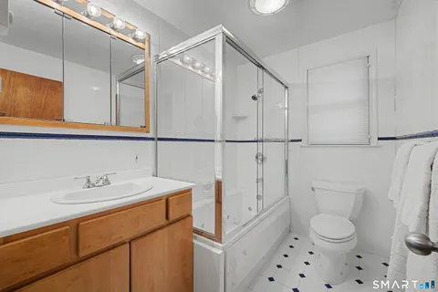 a bathroom with a tub sink and shower