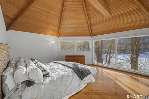 a bed sitting in a bedroom next to a window