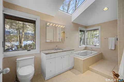 a bathroom with a tub sink and shower