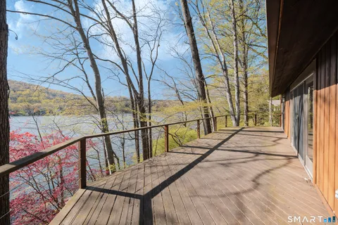 a view of wooden balcony and trees