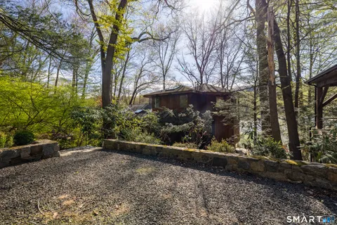 a kitchen with stainless steel appliances granite countertop a refrigerator a sink dishwasher a stove and white countertops with cabinets