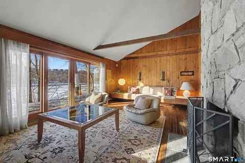 a living room with furniture a lamp and a potted plant