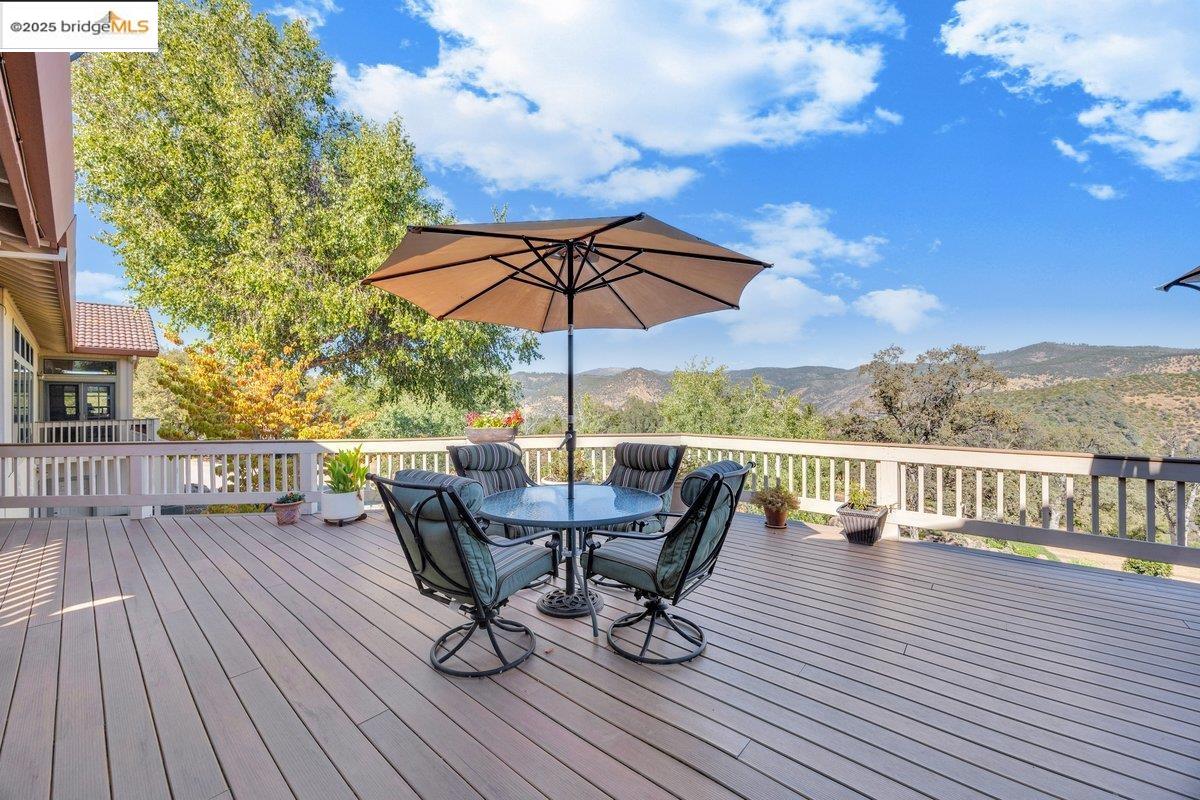 13700 Clements Road Groveland, CA 95321 - Photo 57 of 93 Wooden terrace featuring a mountain view and outdoor dining space