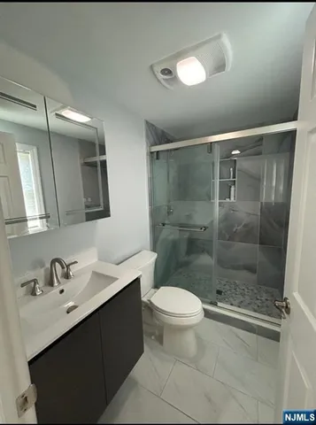 a bathroom with a sink toilet and shower