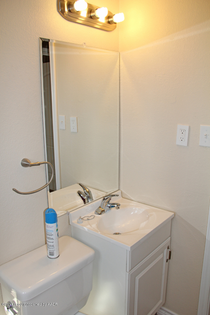 4612 Parker Street Amarillo, TX 79110 - Photo 14 of 17 a bathroom with a sink and a mirror