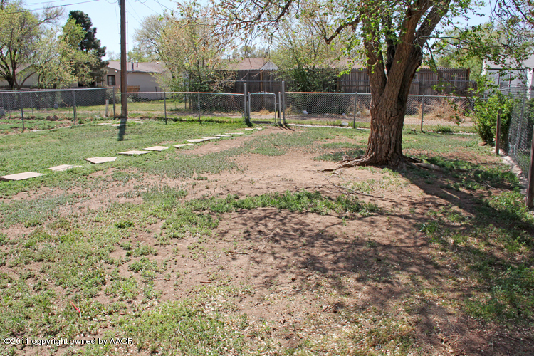 4612 Parker Street Amarillo, TX 79110 - Photo 16 of 17 a backyard of a house with lots of green space
