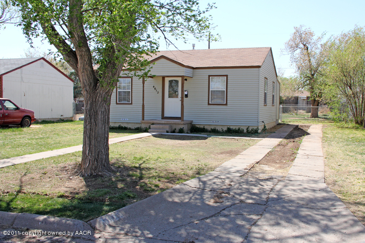 4612 Parker Street Amarillo, TX 79110 - Photo 2 of 17 a front view of a house with a yard