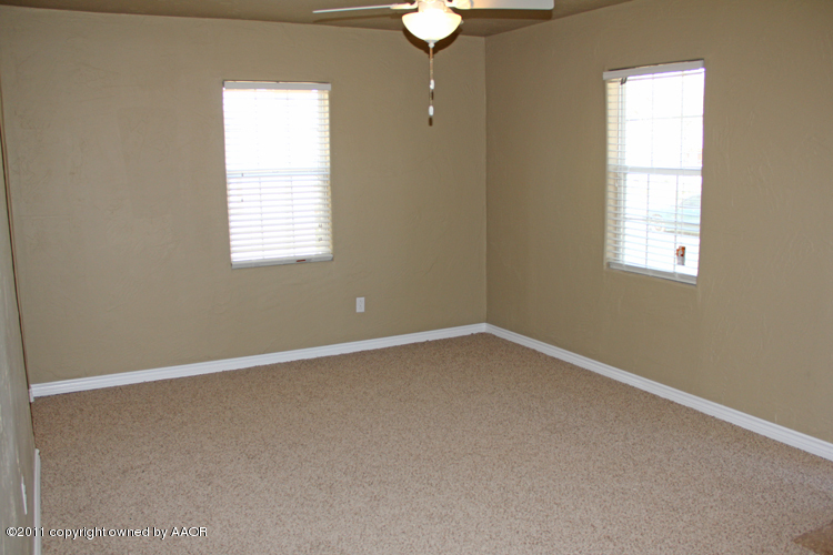 4612 Parker Street Amarillo, TX 79110 - Photo 5 of 17 an empty room with a window