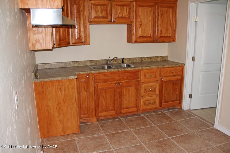 4612 Parker Street Amarillo, TX 79110 - Photo 7 of 17 a bathroom with a granite countertop sink and a mirror