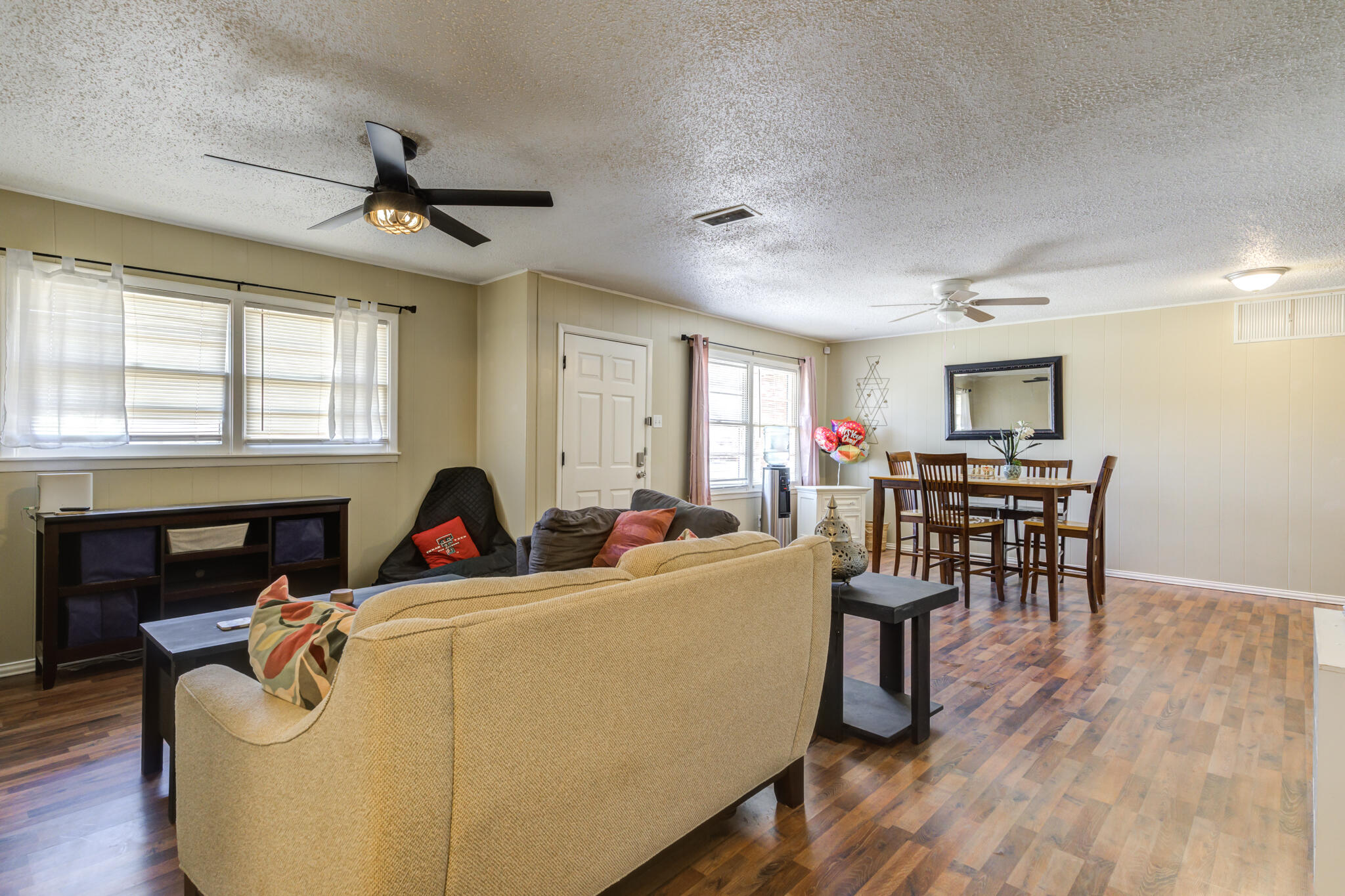 2812 62nd Street Lubbock, TX 79413 - Photo 14 of 45 a living room with furniture a fireplace and a flat screen tv