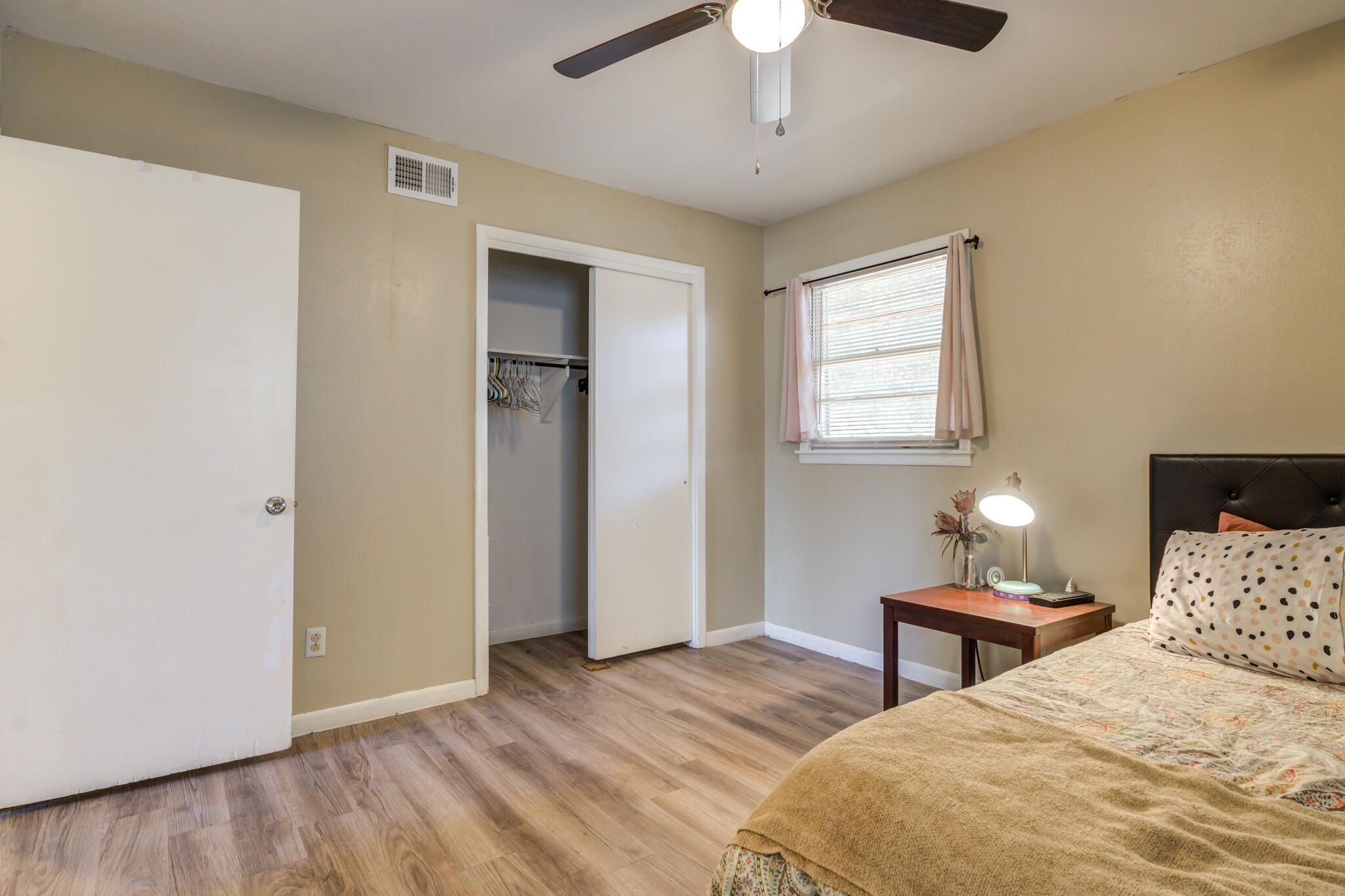 2812 62nd Street Lubbock, TX 79413 - Photo 36 of 45 a bedroom with a bed and a chandelier