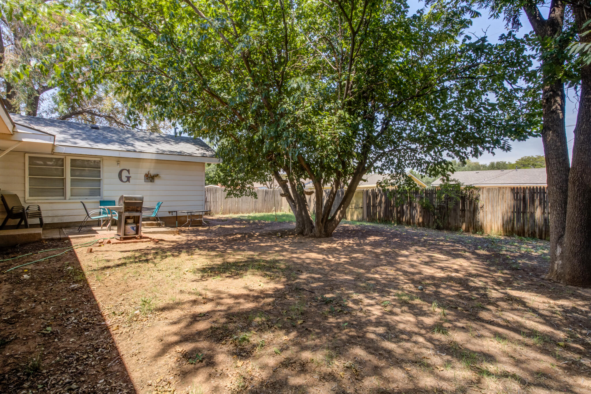 2812 62nd Street Lubbock, TX 79413 - Photo 42 of 45 a view of a backyard with a large tree