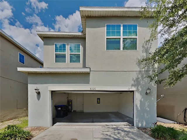 a front view of a house with garage