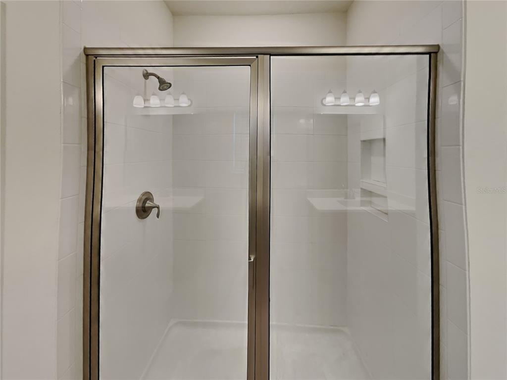 8326 Bryce Canyon Avenue Windermere, FL 34786 - Photo 12 of 20 a bathroom with a glass shower door