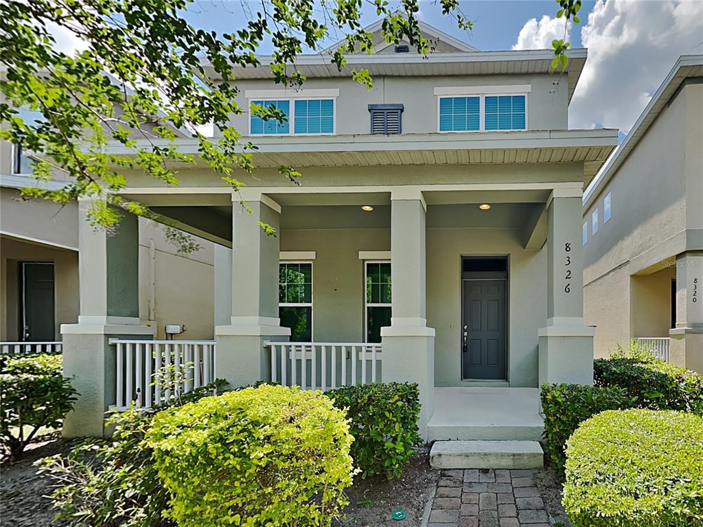 8326 Bryce Canyon Avenue Windermere, FL 34786 - Photo 2 of 20 a front view of a house with a lots of flower plants