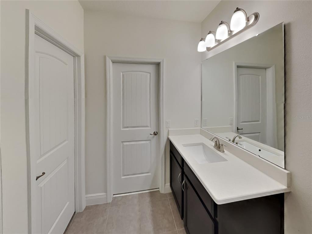8326 Bryce Canyon Avenue Windermere, FL 34786 - Photo 10 of 20 a bathroom with a sink vanity and a mirror