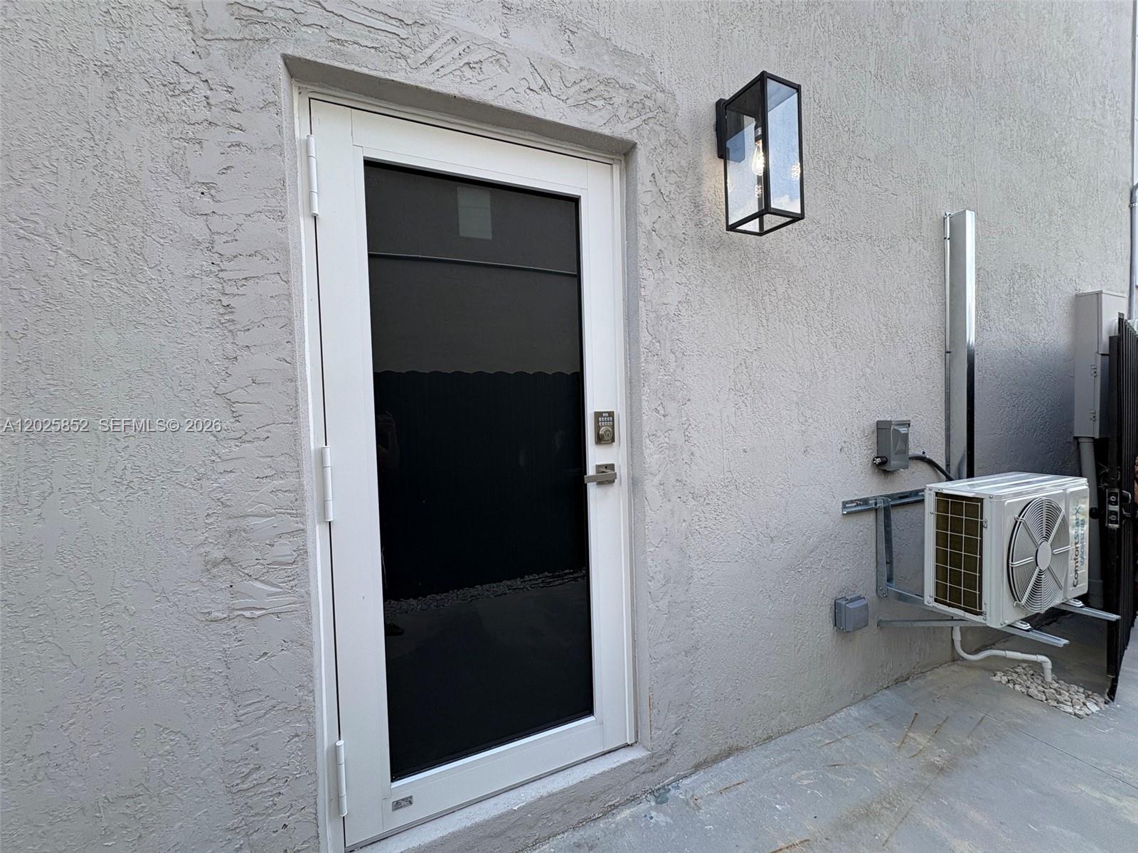 12948 Southwest 265th Terrace, Unit STUDIO Homestead, FL 33032 - Photo 4 of 16 a room with a bench and a mirror