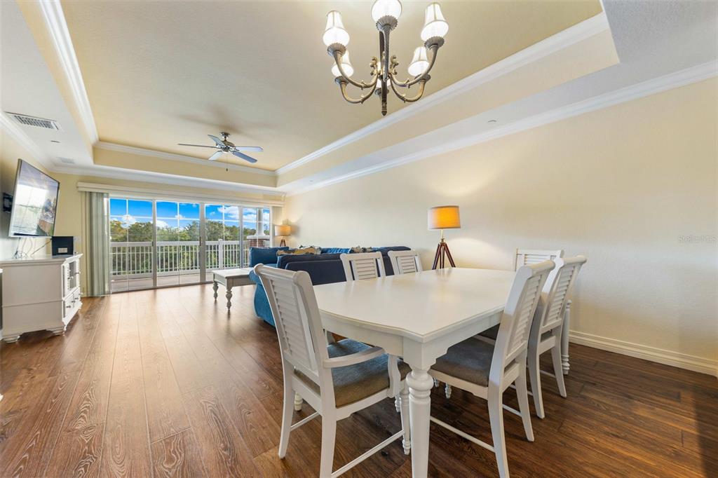 7612 Cabana Court, Unit 303 Reunion, FL 34747 - Photo 12 of 23 a view of a dining room with furniture window and wooden floor