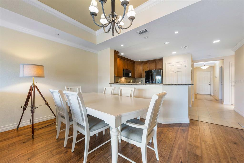 7612 Cabana Court, Unit 303 Reunion, FL 34747 - Photo 13 of 23 a view of a dining room with furniture and wooden floor