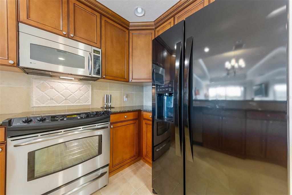7612 Cabana Court, Unit 303 Reunion, FL 34747 - Photo 9 of 23 a kitchen with granite countertop cabinets and steel stainless steel appliances