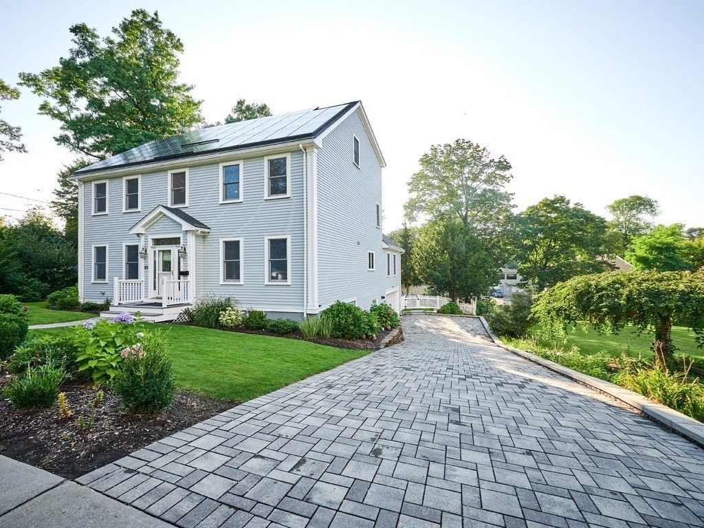 20 Garland Road Newton, MA 02459 - Photo 1 of 41 a view of a white house with a yard and potted plants