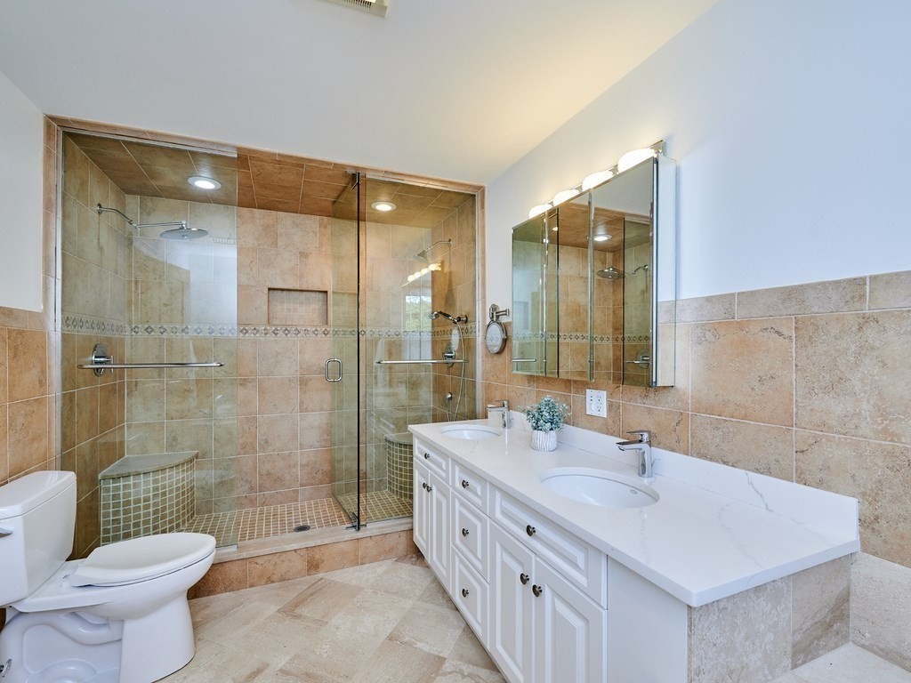 20 Garland Road Newton, MA 02459 - Photo 22 of 41 a bathroom with a double vanity sink toilet and shower