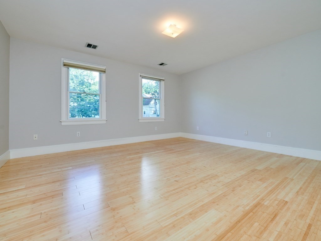 20 Garland Road Newton, MA 02459 - Photo 27 of 41 an empty room with wooden floor and windows