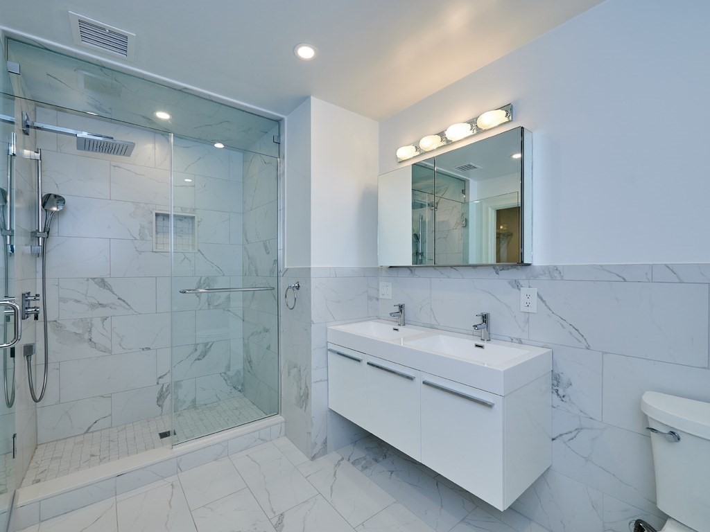 20 Garland Road Newton, MA 02459 - Photo 28 of 41 a bathroom with a double vanity sink mirror and shower