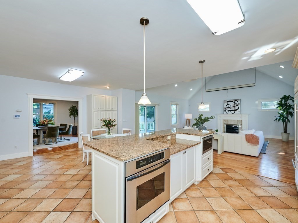 20 Garland Road Newton, MA 02459 - Photo 3 of 41 a open kitchen with stainless steel appliances granite countertop a stove oven and a dining table with the kitchen view
