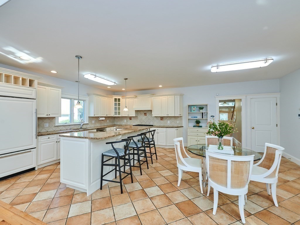 20 Garland Road Newton, MA 02459 - Photo 5 of 41 a kitchen with a dining table chairs and white appliances