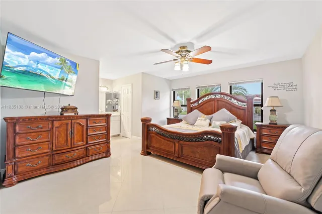 a bedroom with furniture and a flat screen tv