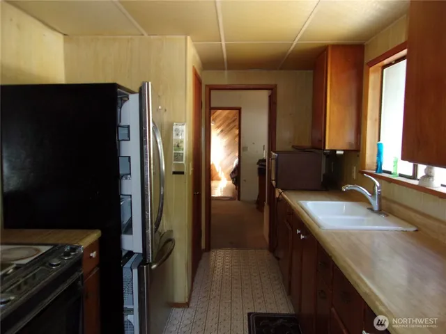 a kitchen with a refrigerator and a sink