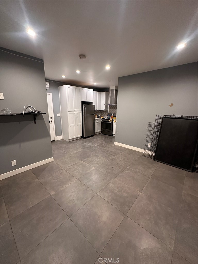 8963 Mercedes Avenue Arleta, CA 91331 - Photo 1 of 7 a view of a room with a refrigerator