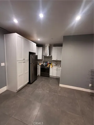 a kitchen with refrigerator and cabinets