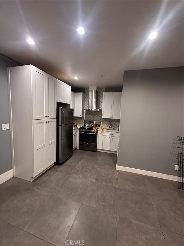 8963 Mercedes Avenue Arleta, CA 91331 - Photo 2 of 7 a kitchen with refrigerator and cabinets